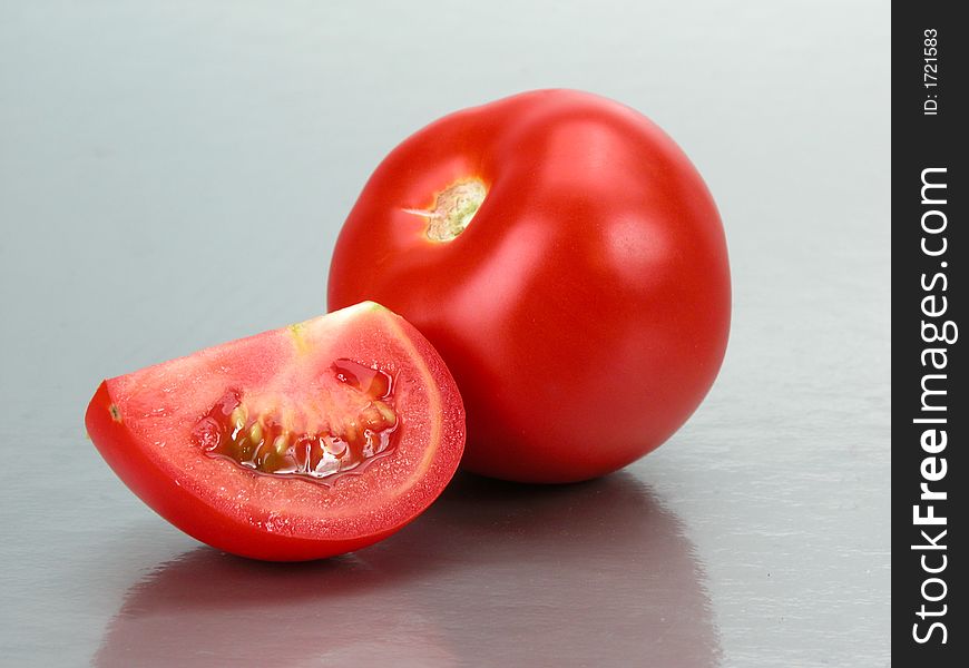Some tomatoes on a grey background. Some tomatoes on a grey background