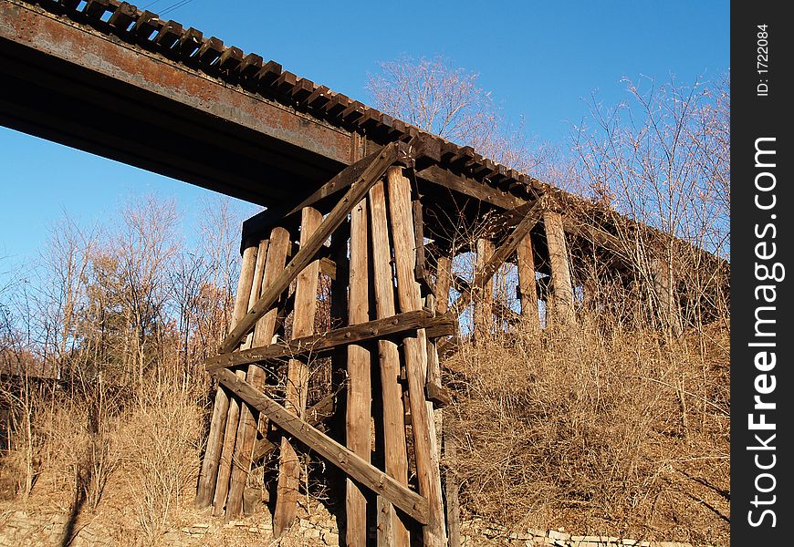 Wooden railroad bridge cross beams. Wooden railroad bridge cross beams