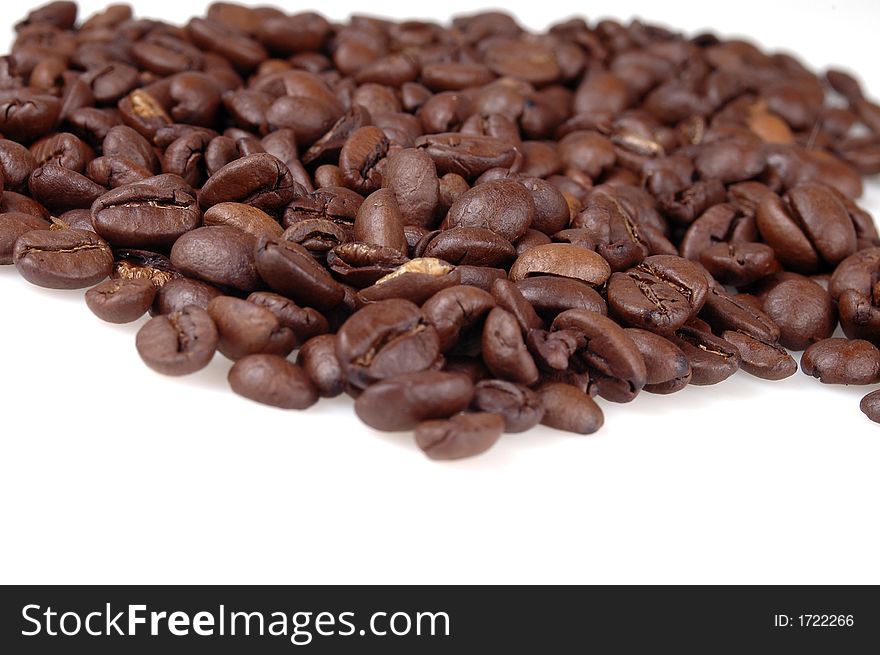 A pile of coffee beans against a white background. A pile of coffee beans against a white background.