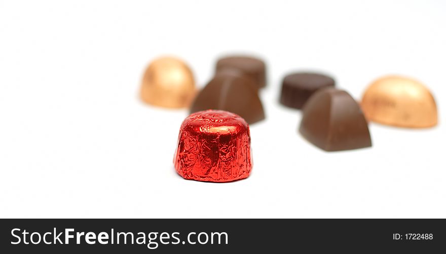 Fancy tasty chocolates over white background with selective focus. Fancy tasty chocolates over white background with selective focus.