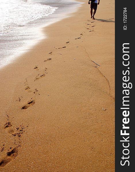 Partial view of the shore and the footsteps of somebody in the bay of San Agustinillo in the southern state of Oaxaca in  Mexico, Latin America. Partial view of the shore and the footsteps of somebody in the bay of San Agustinillo in the southern state of Oaxaca in  Mexico, Latin America