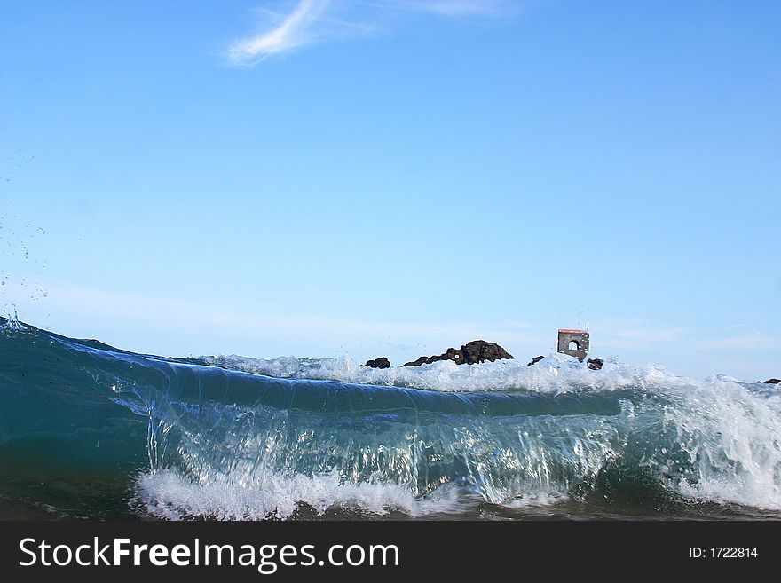 Partial view of a wave and a small church in the bay of San Agustinillo in the southern state of Oaxaca in  Mexico, Latin America. Partial view of a wave and a small church in the bay of San Agustinillo in the southern state of Oaxaca in  Mexico, Latin America