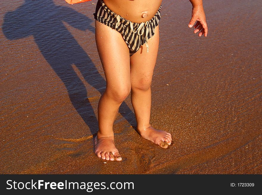 Partial view of a boy coming out of the water in san agustinillo, Oaxaca, Mexico, Latin America. Partial view of a boy coming out of the water in san agustinillo, Oaxaca, Mexico, Latin America