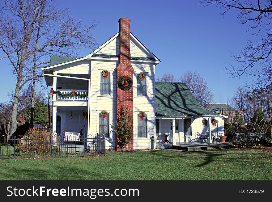 Old white farm house decorated for Christmas. Old white farm house decorated for Christmas