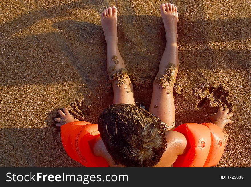 Boy watching the sea siiting at the beach of San Agustinillo in the southern state of Oaxaca in Mexico, Latinamerica