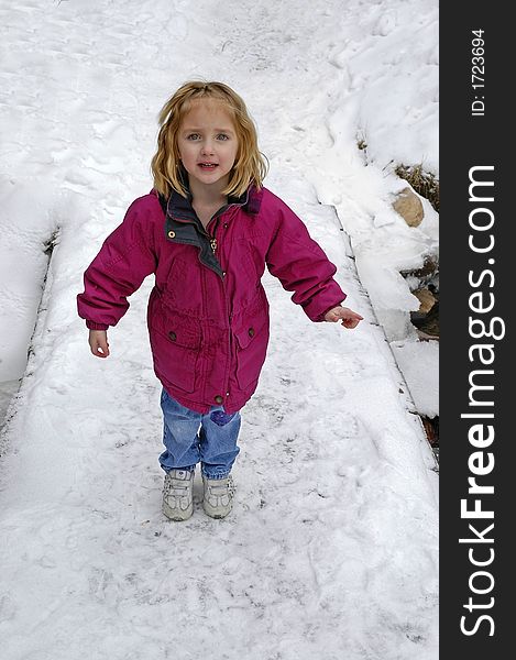 Little girl crossing foot bridge over snow and water. Little girl crossing foot bridge over snow and water