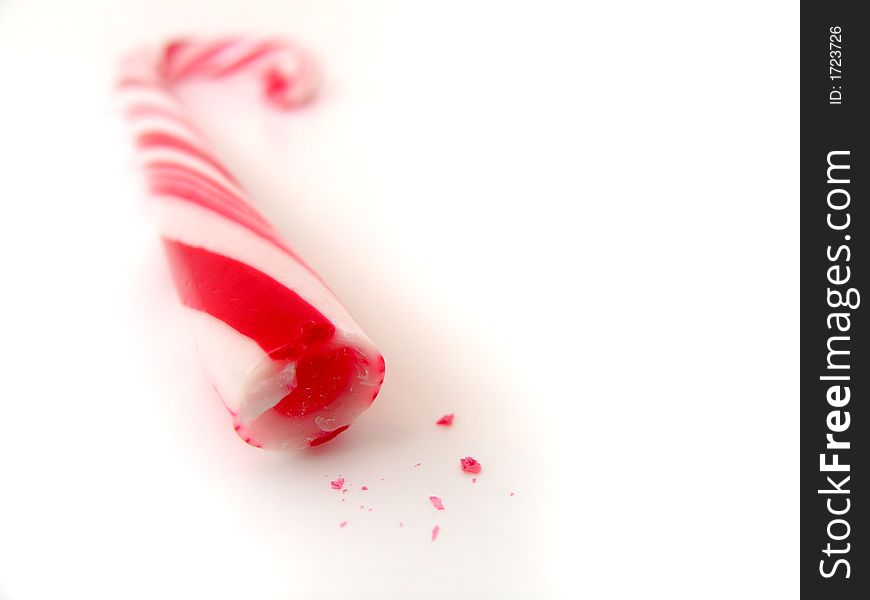 Closeup isolated candy cane with small chips. Closeup isolated candy cane with small chips