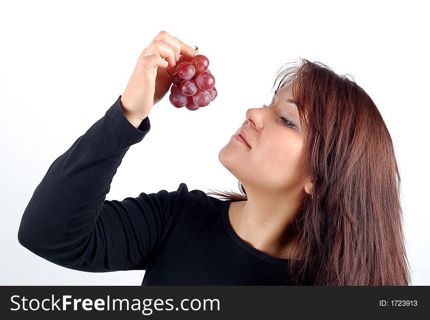 Attractive woman tasting grapes on white background. Attractive woman tasting grapes on white background