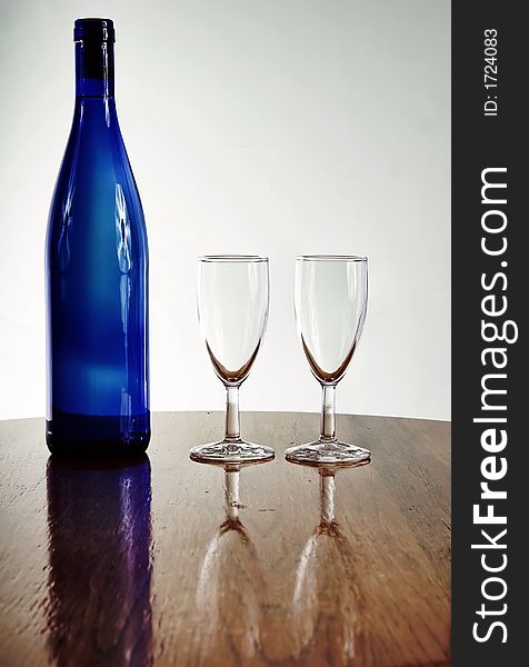 Blue wine bottle with glasses