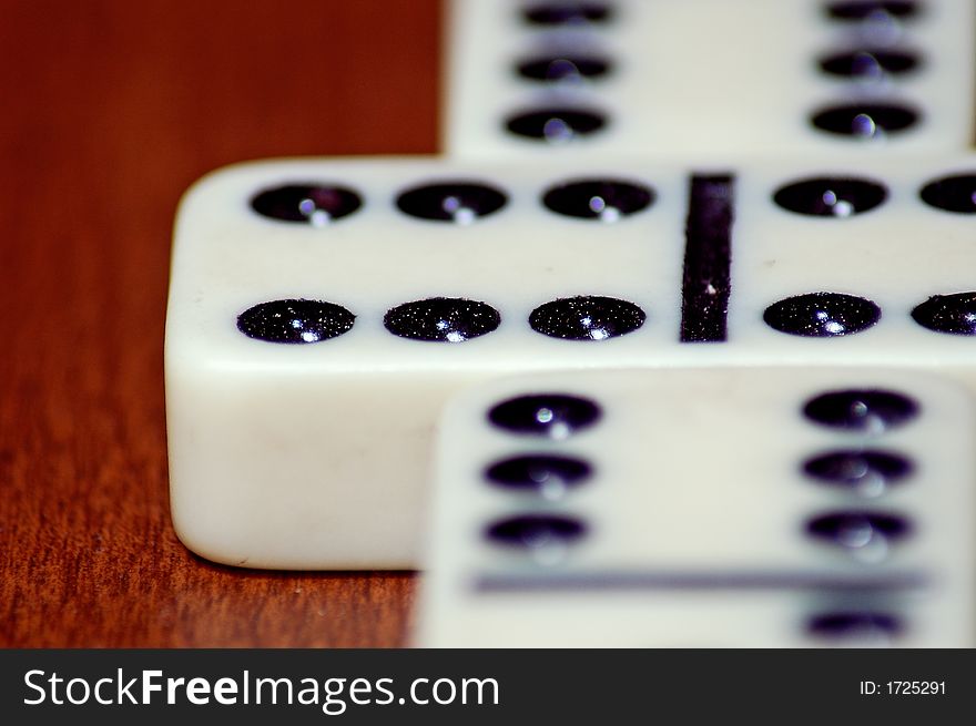 Detailed macro close up shot of a set of dominos. Setup correctly with the double 6 as a starting point issuing the game at hand.