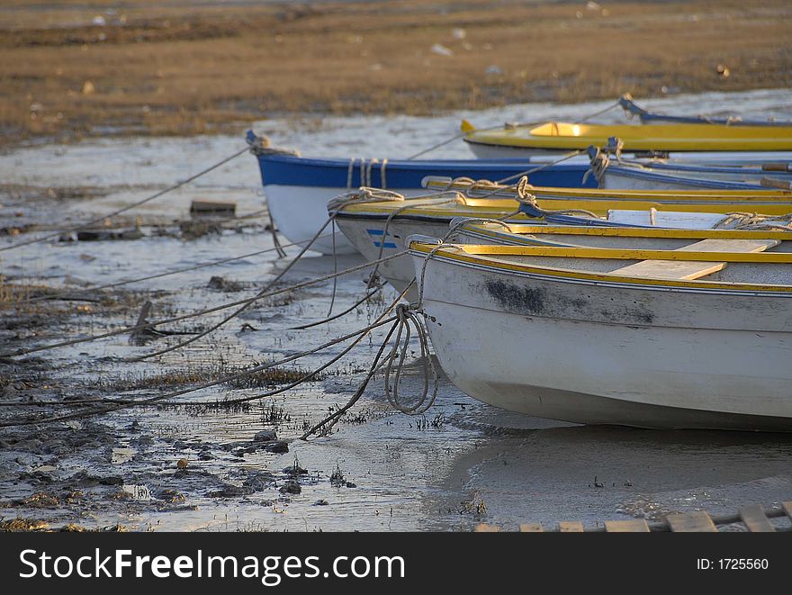 Some boats on a almost dry lake. Some boats on a almost dry lake