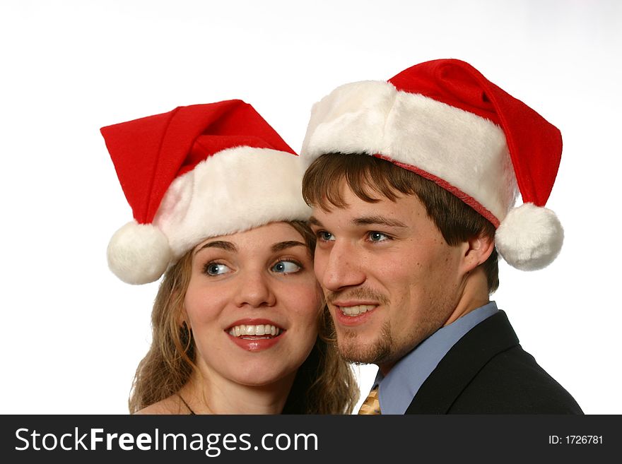 Young man and beautiful young lady with santa hats isolated on white space. Young man and beautiful young lady with santa hats isolated on white space