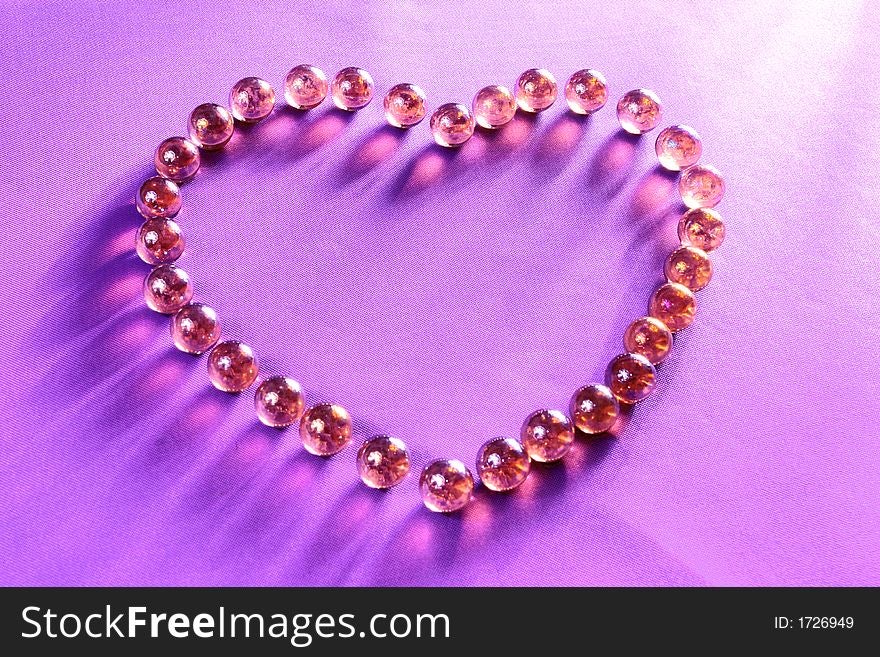 A full heart made by glisten balls on the purple background. A full heart made by glisten balls on the purple background