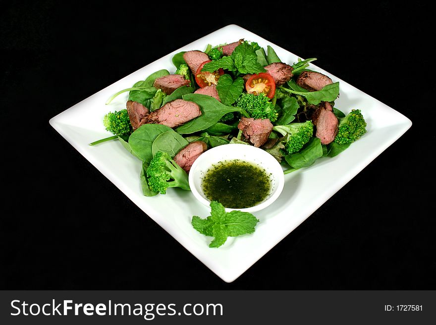 Delicious cold lamb salad with mint sauce. Delicious cold lamb salad with mint sauce.