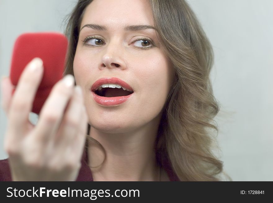 Pretty brunette is very happy to receive a present in a red box