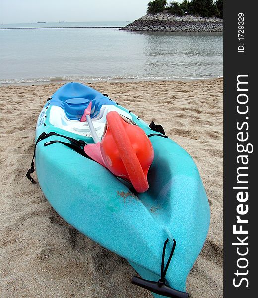 A kayak canoe on a deserted beach. A kayak canoe on a deserted beach.