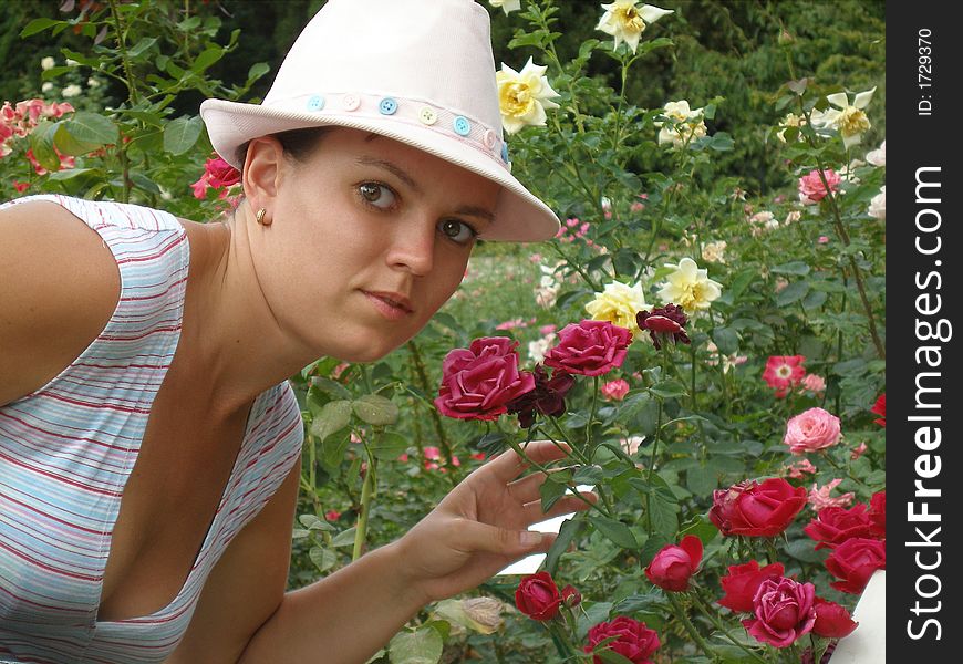 Portrait of the girl on background of the roses in garden. Portrait of the girl on background of the roses in garden