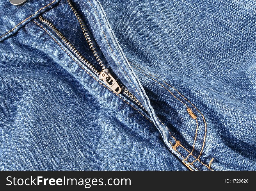 The Open Zipper of a Pair of Jeans is Featured. The Open Zipper of a Pair of Jeans is Featured.