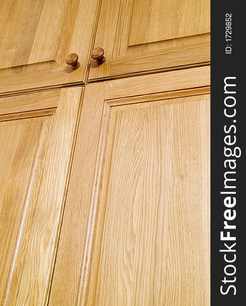 Wooden oak wardrobe door two handles closeup. Wooden oak wardrobe door two handles closeup