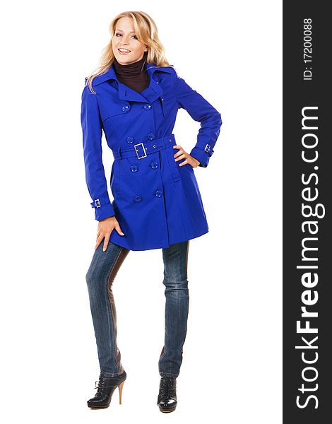 Pretty model in a blue coat against white background