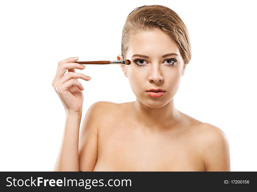 Portrait of a beautiful young woman applying makeup. Portrait of a beautiful young woman applying makeup