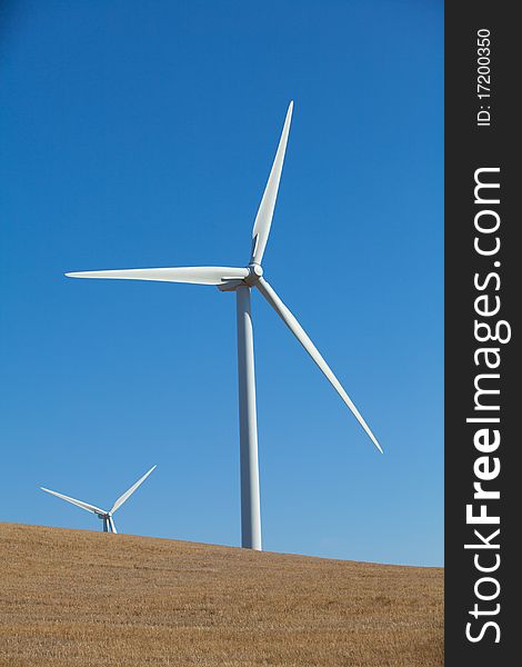 A wind farm in rolling foothills