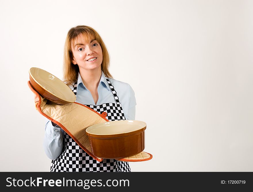 A horizontal image of a cook or mother holding open the lid of a crock pot to show inside,inside empty for editing. A horizontal image of a cook or mother holding open the lid of a crock pot to show inside,inside empty for editing