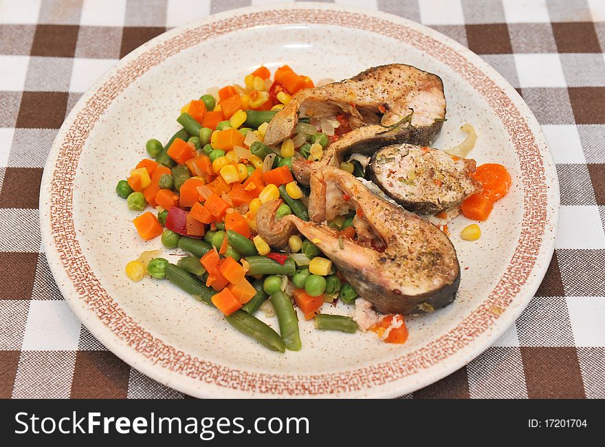 Trout and mixed vegetables on a plate. Trout and mixed vegetables on a plate