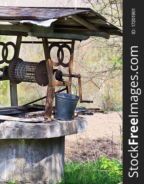 Gray stone well with rope and bucket. Gray stone well with rope and bucket