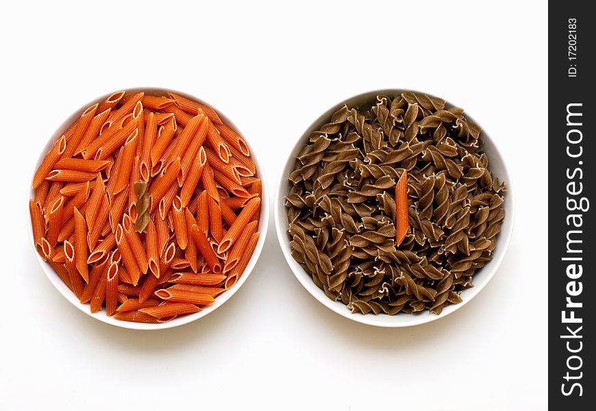 Garlic & herb and chili pasta in bowls on white background. Garlic & herb and chili pasta in bowls on white background