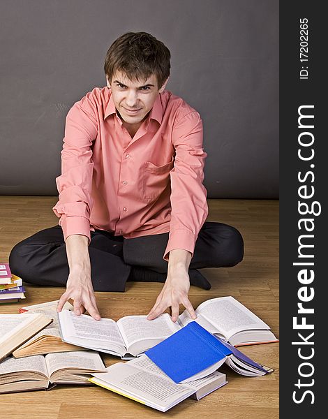 Young boy reading a book on floor