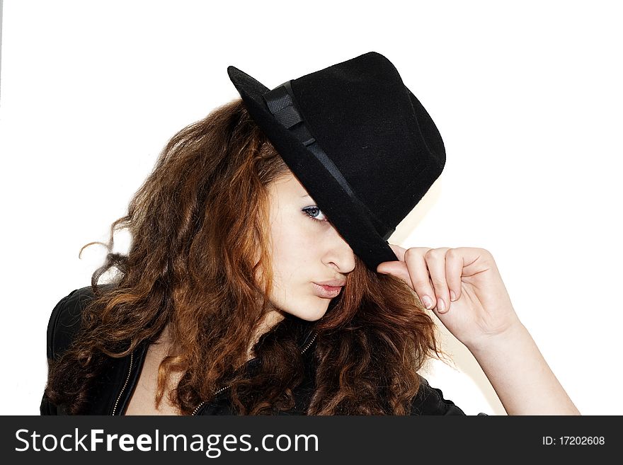 The girl with the black hat covering the half of the face, isolated on a white background. The girl with the black hat covering the half of the face, isolated on a white background