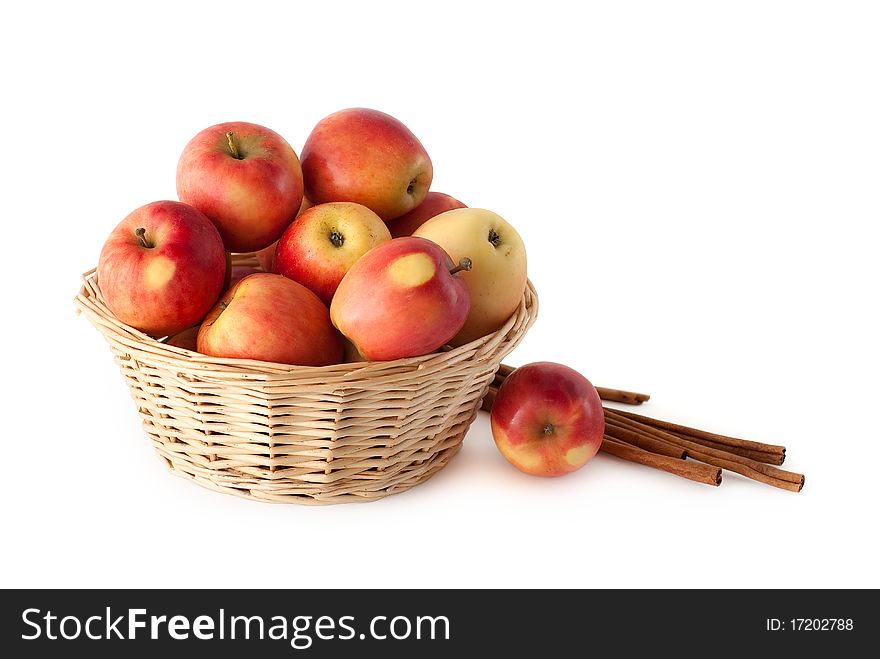 Basket with apples and cinnamon on a white background. Basket with apples and cinnamon on a white background