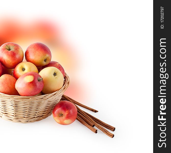 Basket with apples and cinnamon on a white background. Basket with apples and cinnamon on a white background