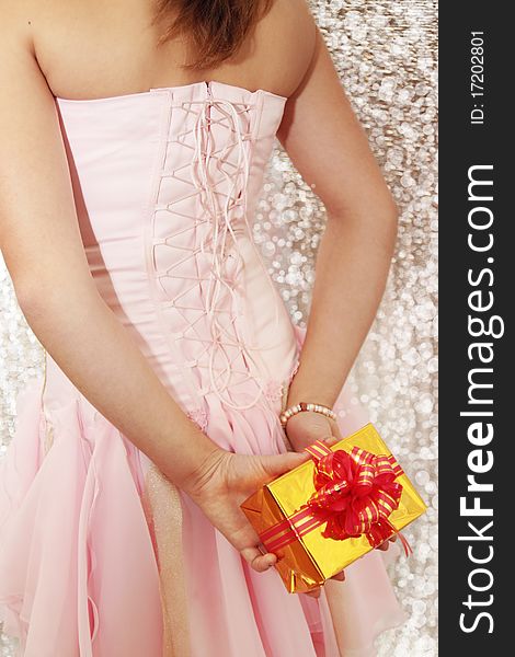 Girl in the pink dress with the gift. Girl in the pink dress with the gift