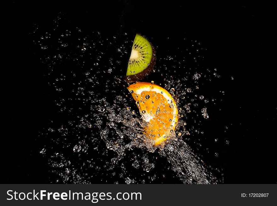 Water Splash with fruit orange and kiwi