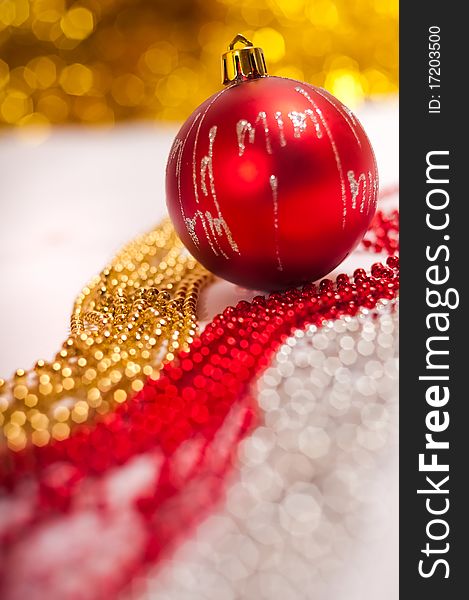 Red Christmas ball with beads on foreground