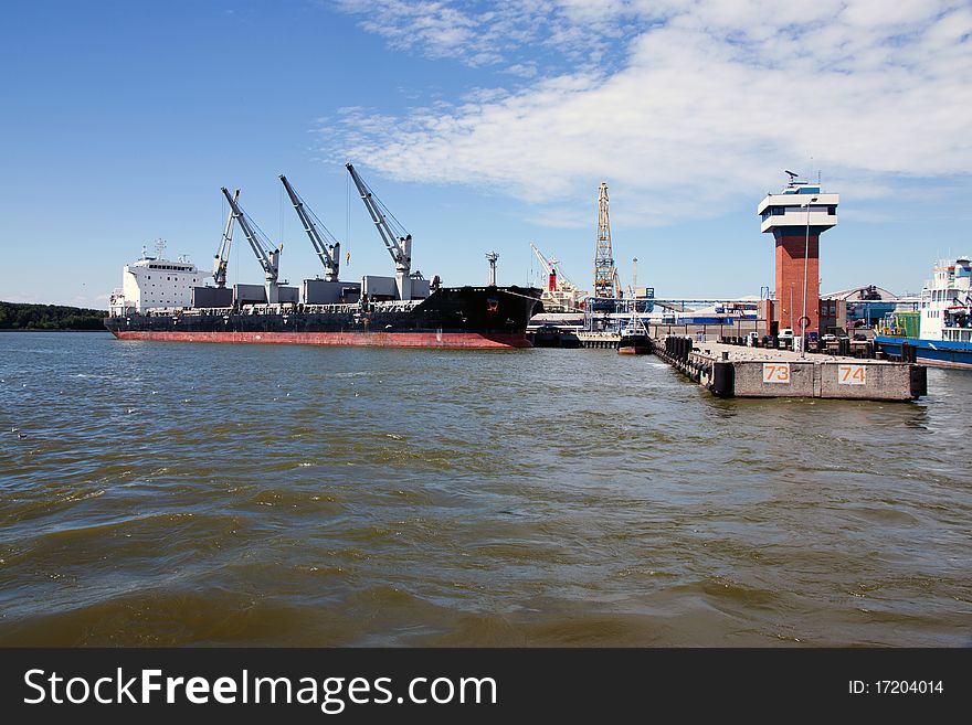 Cargo ship and control tower in sea port