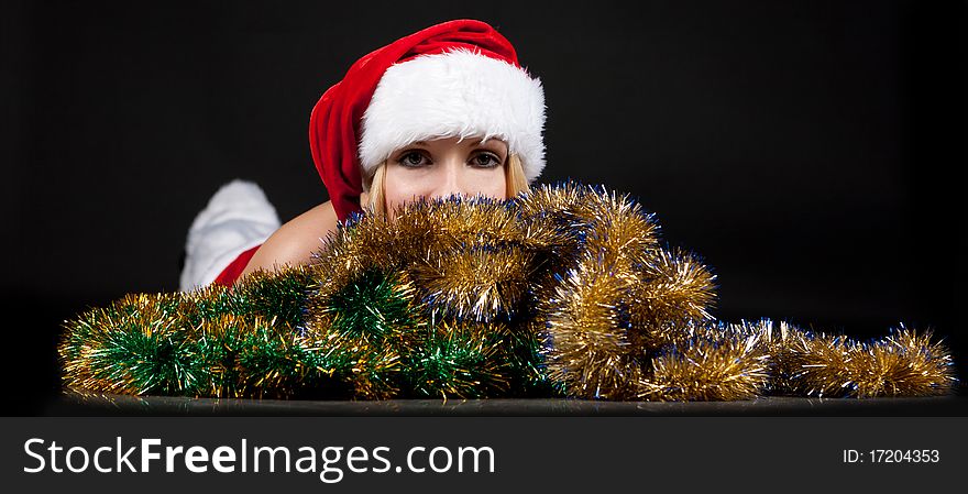 Christmas girl over tinsel on black background