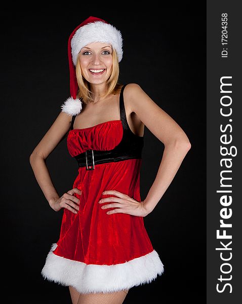 Christmas girl in santa hat on black background