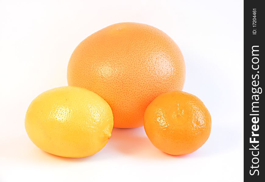 Three healthy citrus fruits isolated on white background