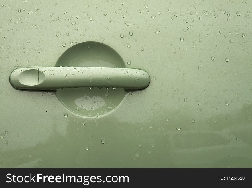 Green handle on the door of the car