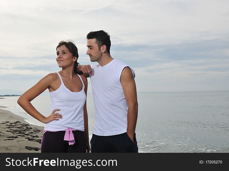 Happy young couple in white clothing have romantic recreation and fun at beautiful beach on vacations. Happy young couple in white clothing have romantic recreation and fun at beautiful beach on vacations
