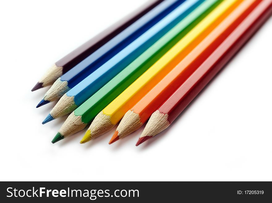 Color pencils arranged in rainbow spectrum order isolated on white background