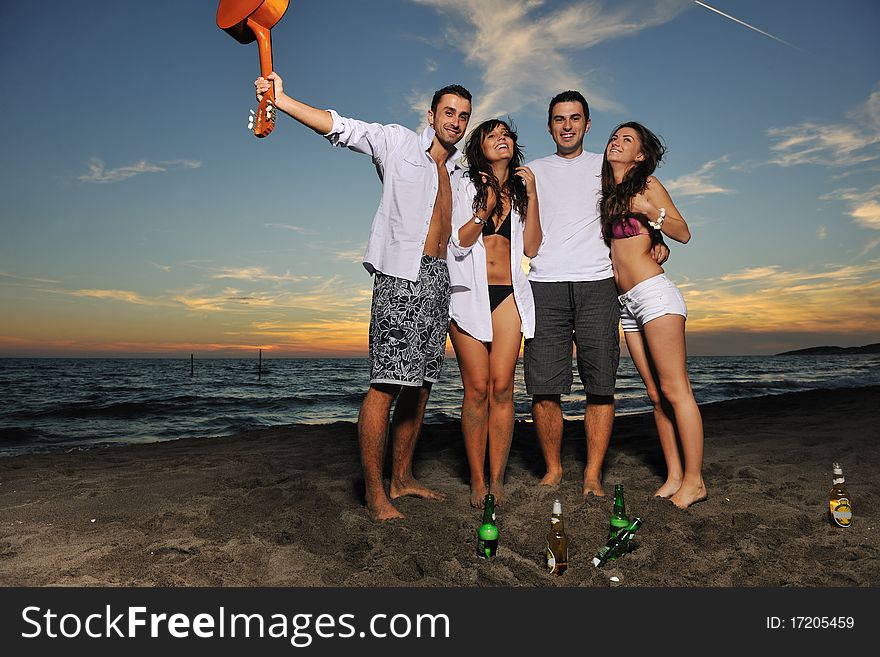 Happy young friends group have fun and celebrate while jumping and running on the beach at the sunset. Happy young friends group have fun and celebrate while jumping and running on the beach at the sunset