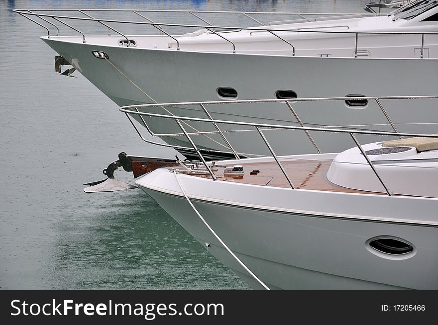 Two white yacht anchoring in harbor, shown as maintenance or marine sport. Two white yacht anchoring in harbor, shown as maintenance or marine sport.