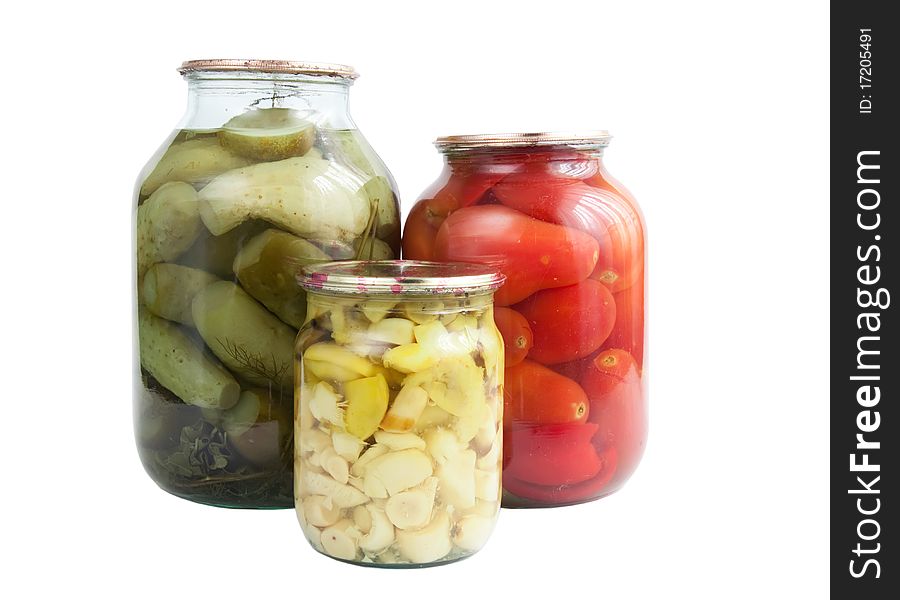 Tinned cucumbers, tomatoes and mushrooms on a white background. Tinned cucumbers, tomatoes and mushrooms on a white background