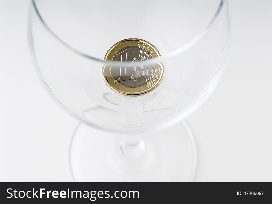 A one euro coin in a crystal glass. A one euro coin in a crystal glass