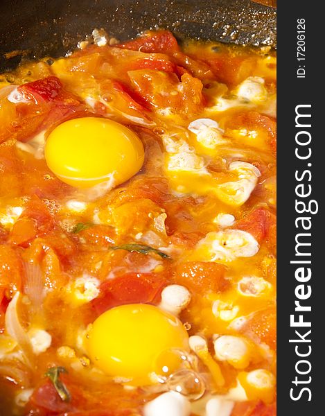 Fried eggs and tomatoes and onion