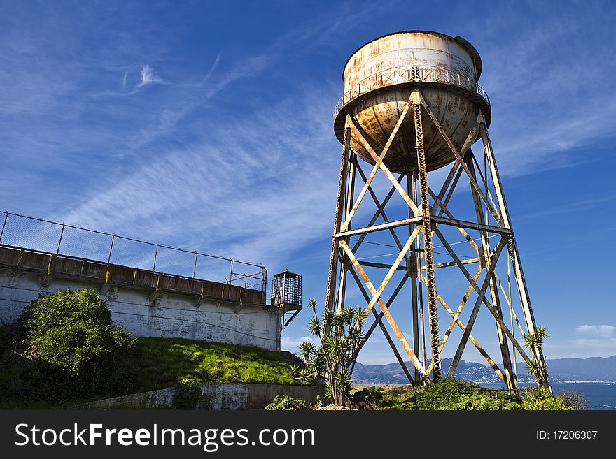 A water tower next to the prison yard. A water tower next to the prison yard